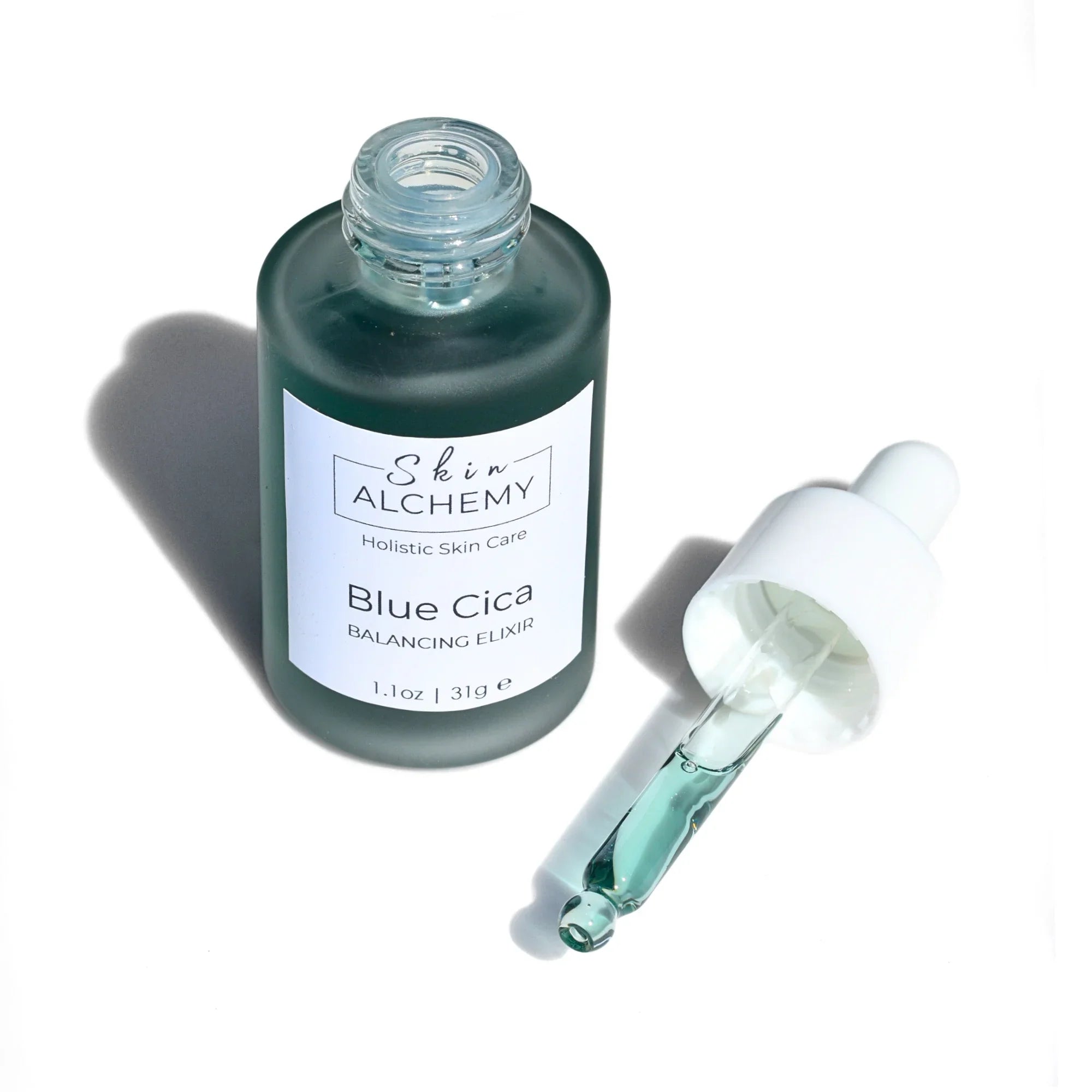 A face oil bottle with dropper on a white background