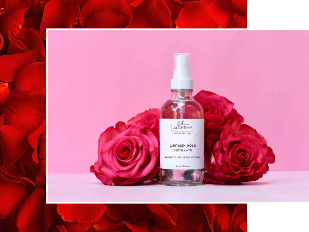 Bottle of skincare product surrounded by red roses on a pink background