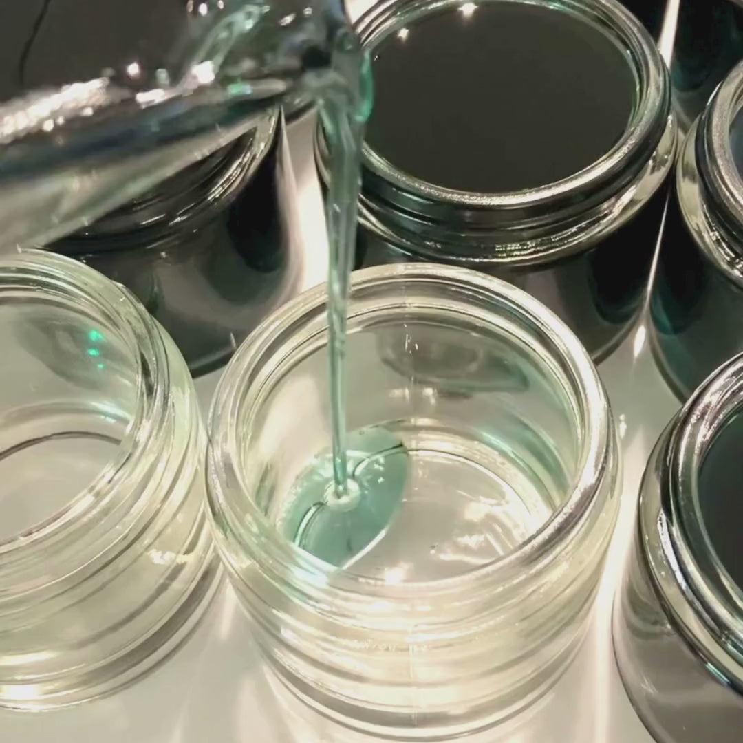 blue liquid being poured into a jar