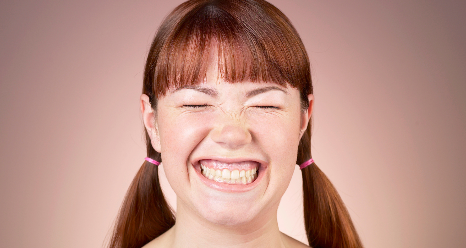 woman smiling with her teeth showing