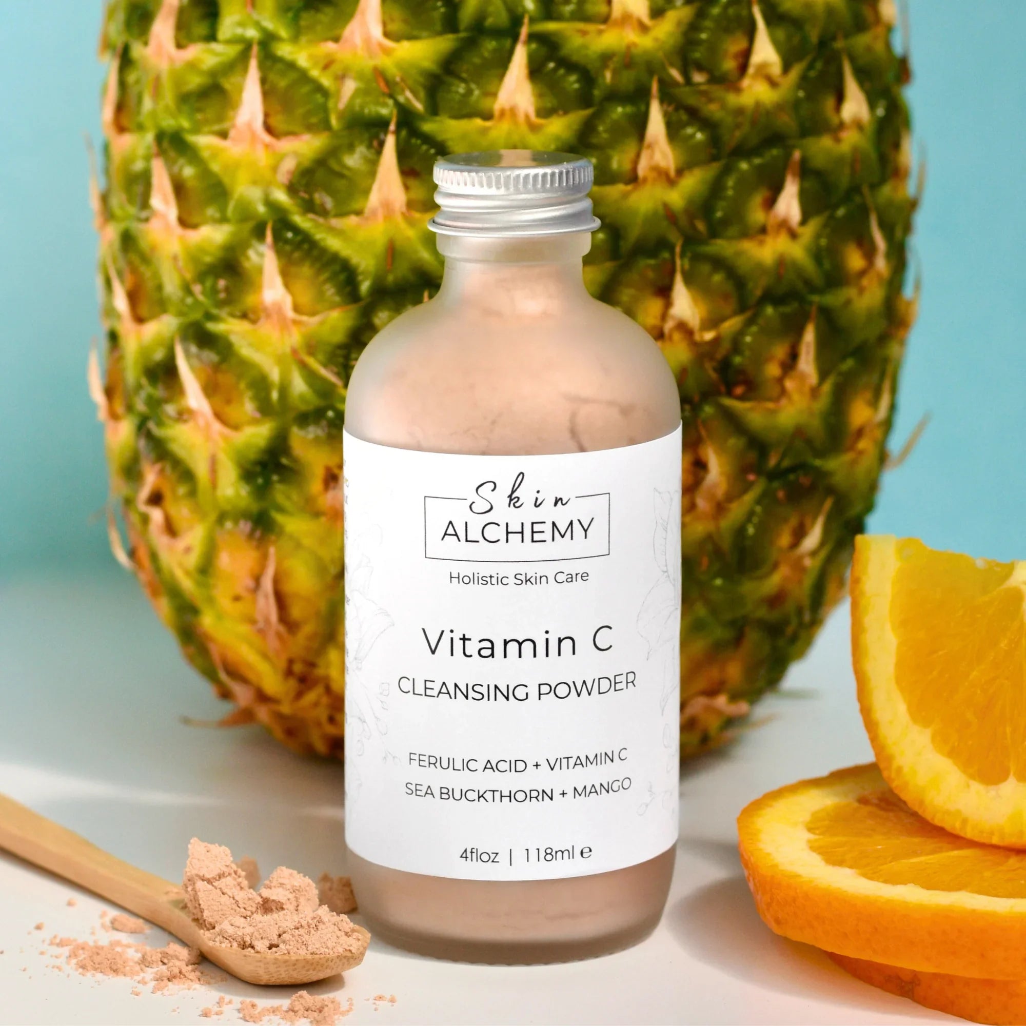 Bottle with orange slices and a pineapple in the background