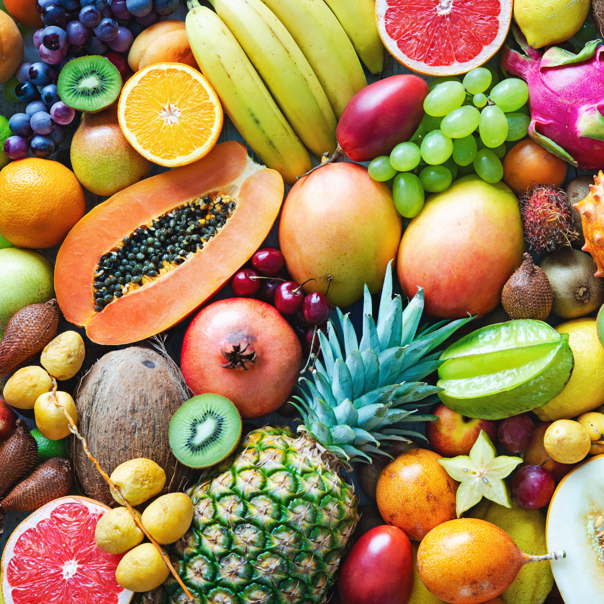 Assorted fruits including bananas, oranges, apples, and various tropical fruits on a colorful background.