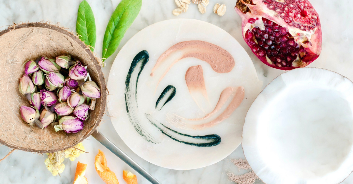 dried flowers, orange peel and pomegranate on a marble surface