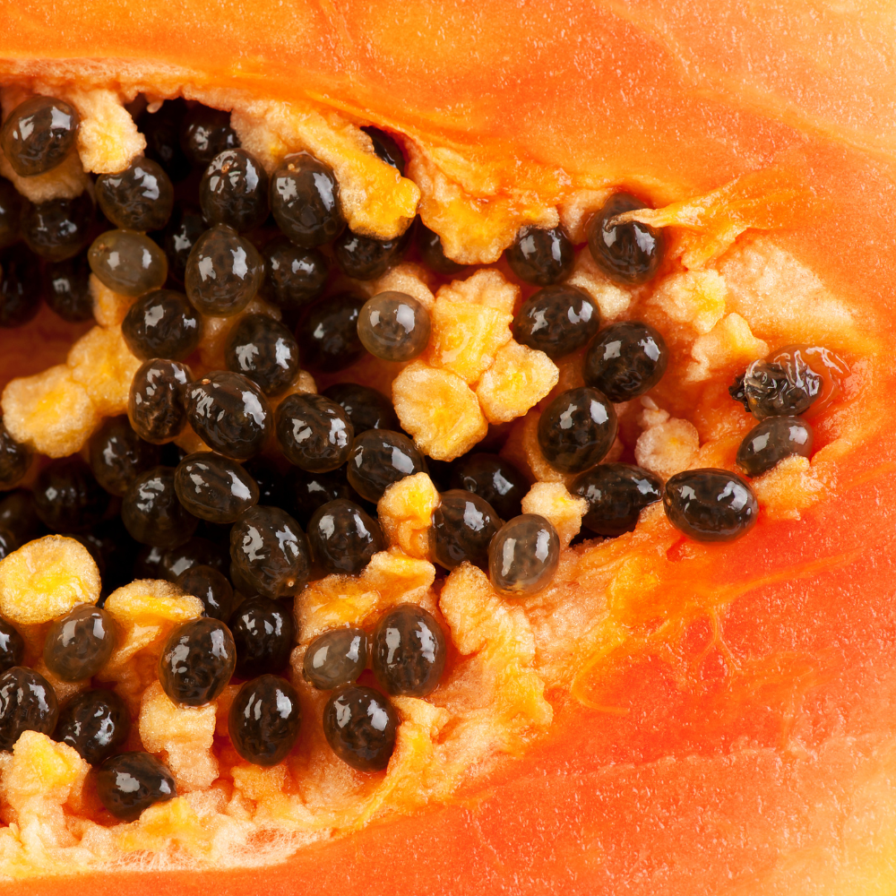 Close-up of a papaya with black seeds inside